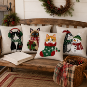 Christmas cat pillow covers set of four in a cozy holiday living room